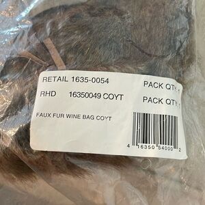 Pottery Barn faux fur wine bag in Coyote. Brand new and unused.